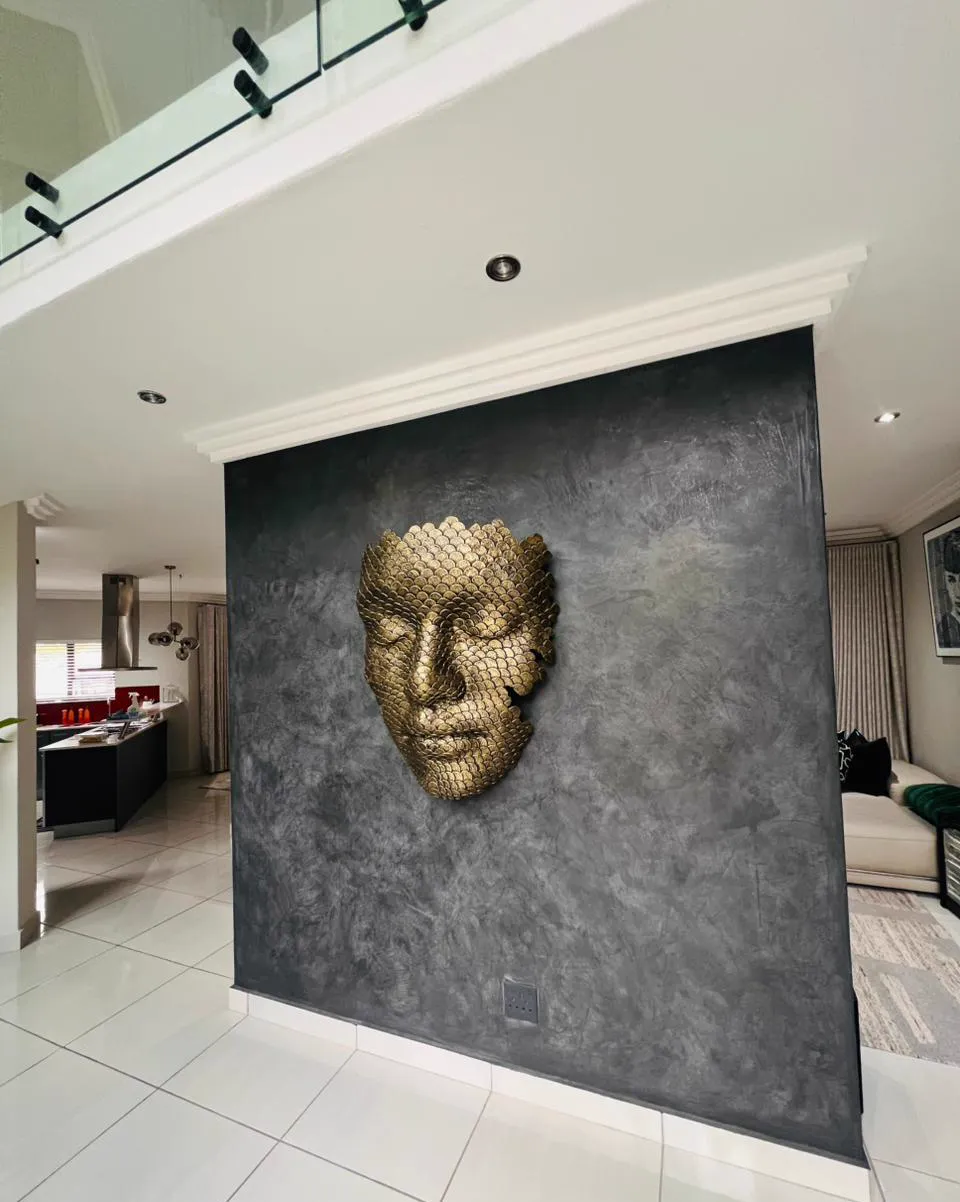 Decorative plaster feature wall with mounted sculptural art piece
