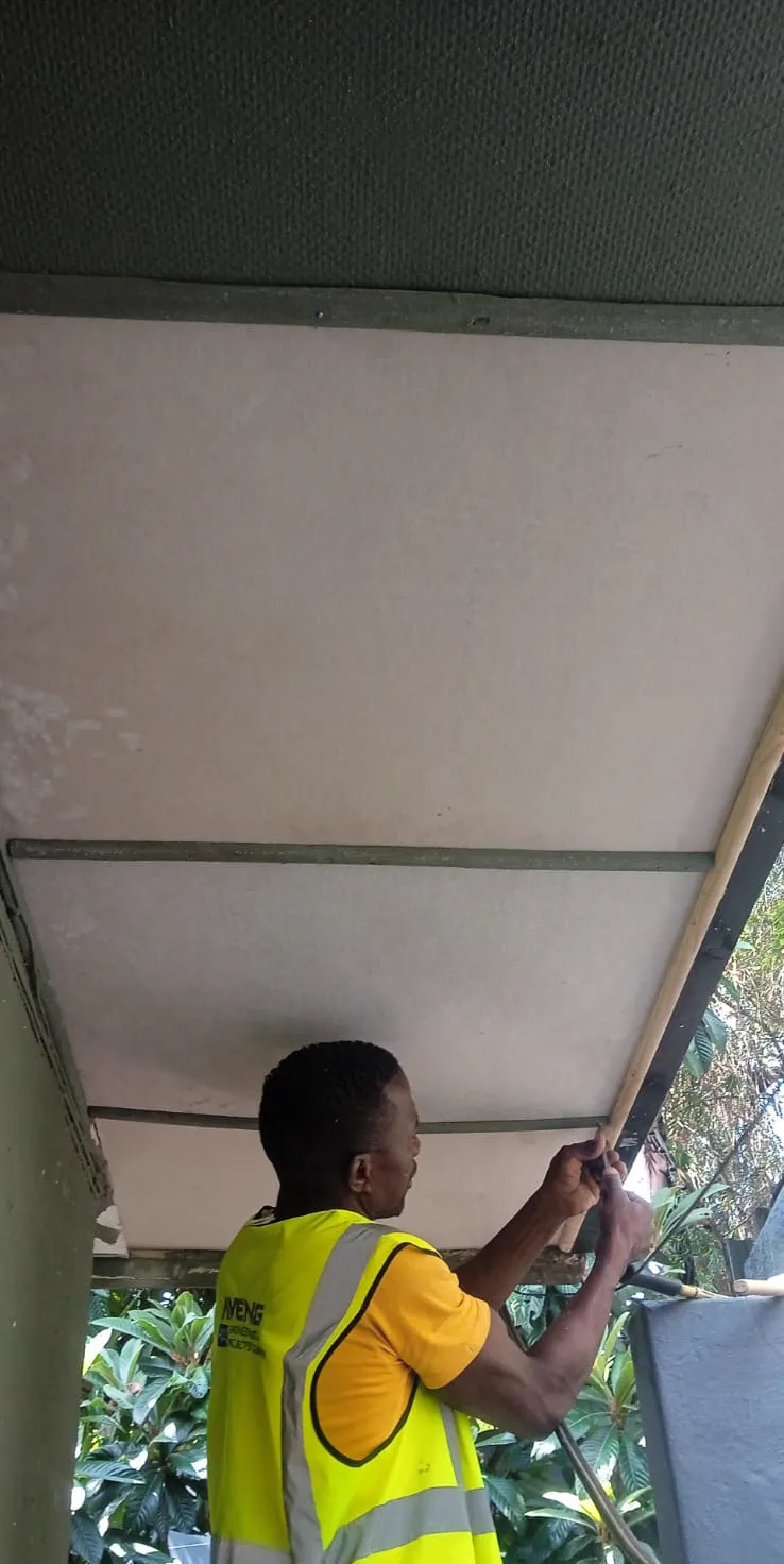 Technician fitting a new exterior ceiling panel
