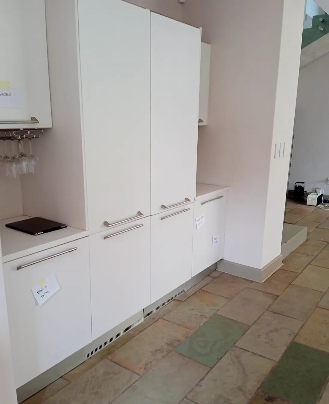 Interior natural stone floor tiling with fitted cabinetry