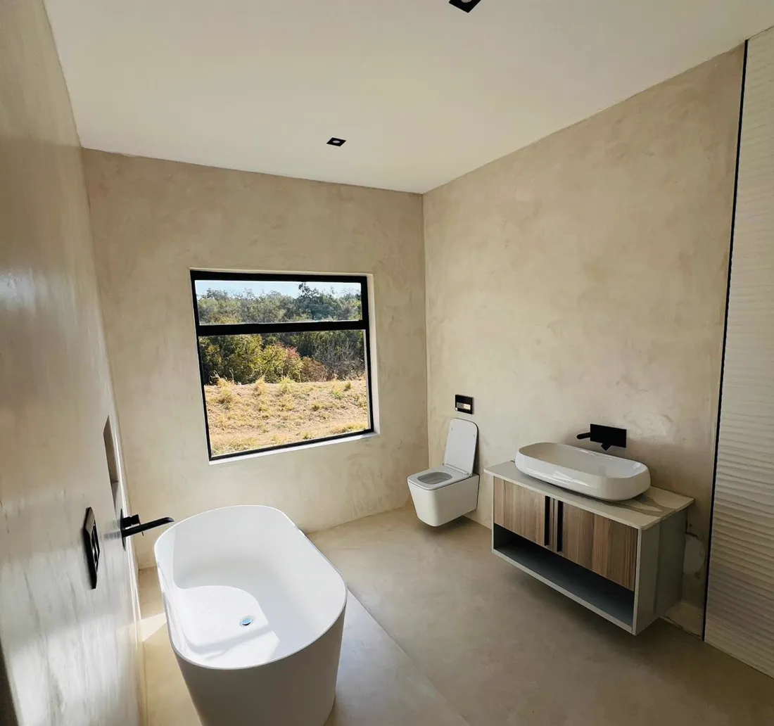 Renovated bathroom with freestanding bath and floating vanity