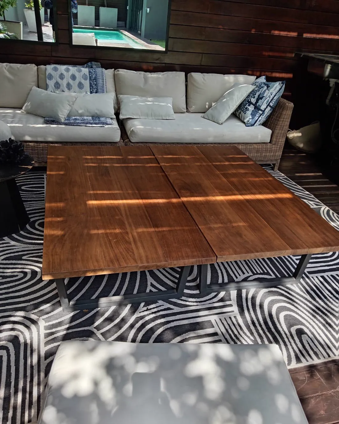 Custom solid timber coffee table on an outdoor patio lounge