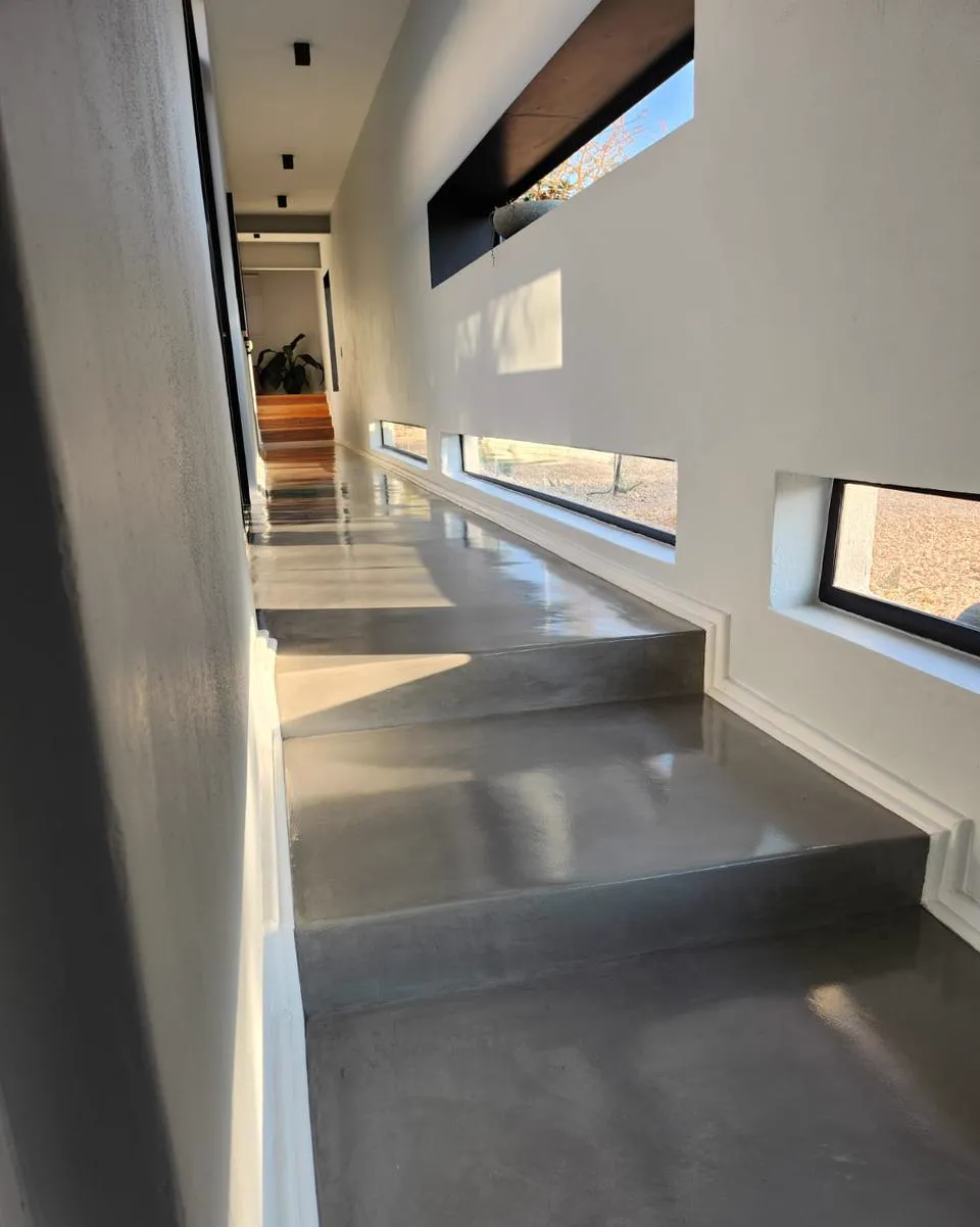 Polished concrete flooring finish along a bright interior corridor